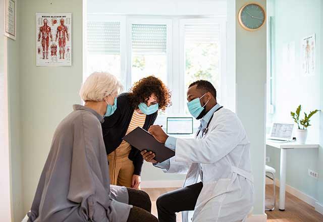 Masked patient in the doctors office